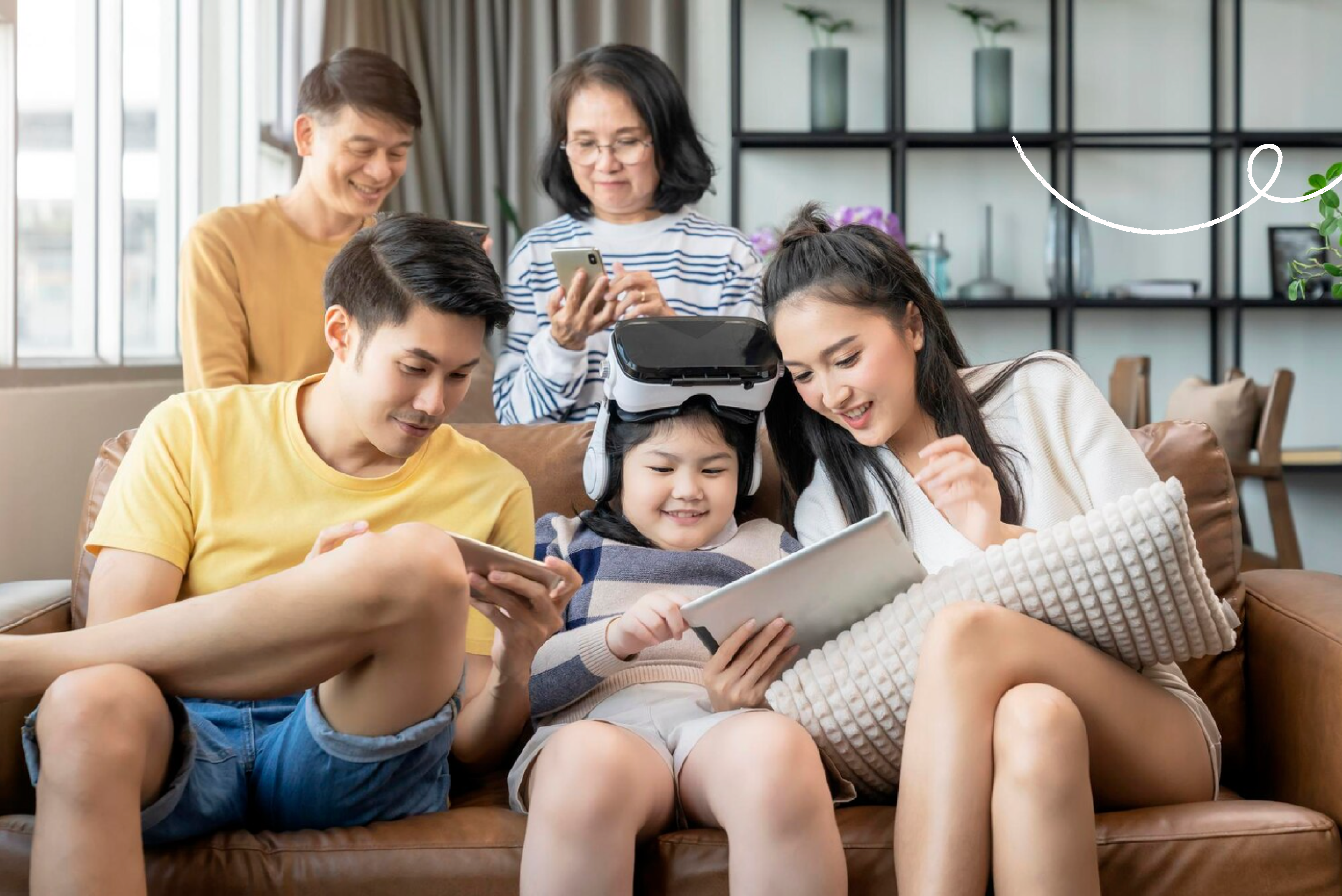 A family sitting in a living room enjoying their phones and tablets. The child is wearing a VR headset.