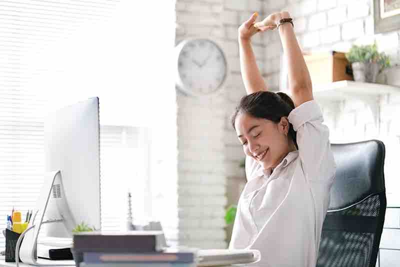 woman stretching at desk