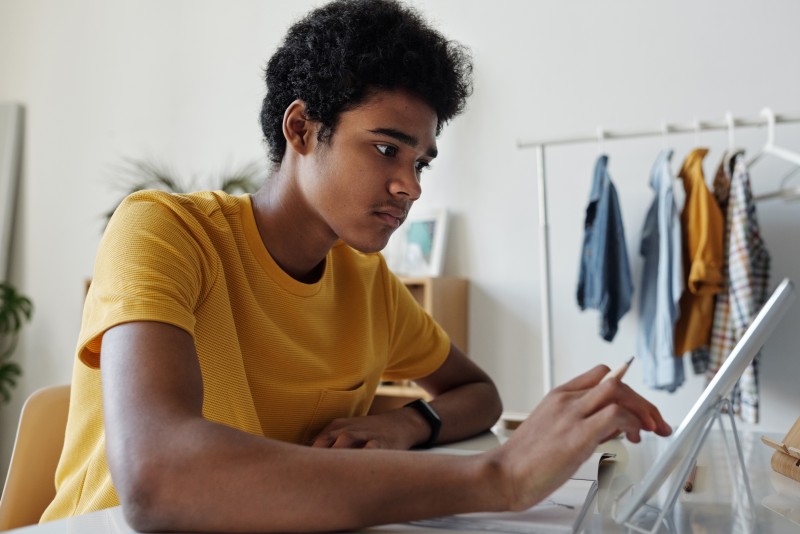 A young person reads A complete guide to eLearning tools for all ages on a tablet